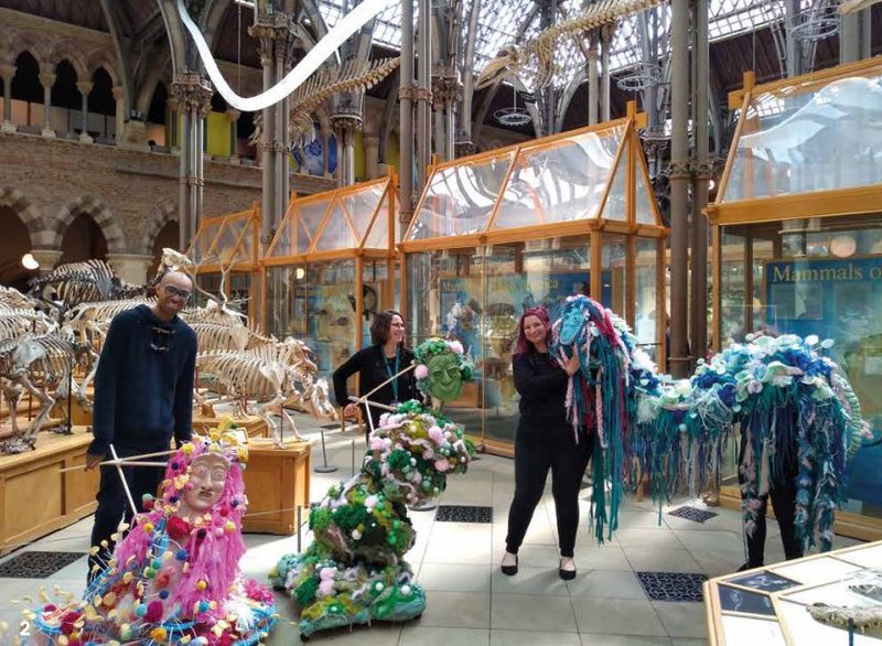 Staff at Oxford Natural History Museum with colourful person sized sculptures from the project